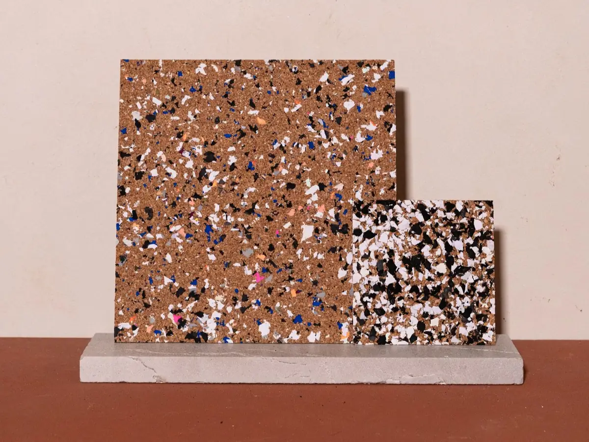 Two cork panels with coloured inlays on a stone base