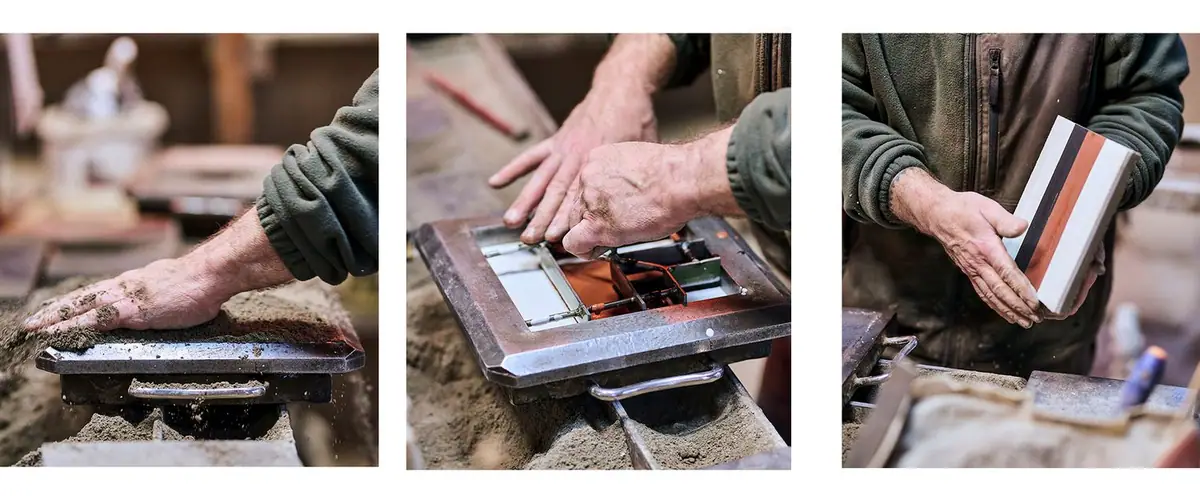 A craftsman's hands at work in the workshop: filling the mould, metal divider with colours and a freshly demoulded tile