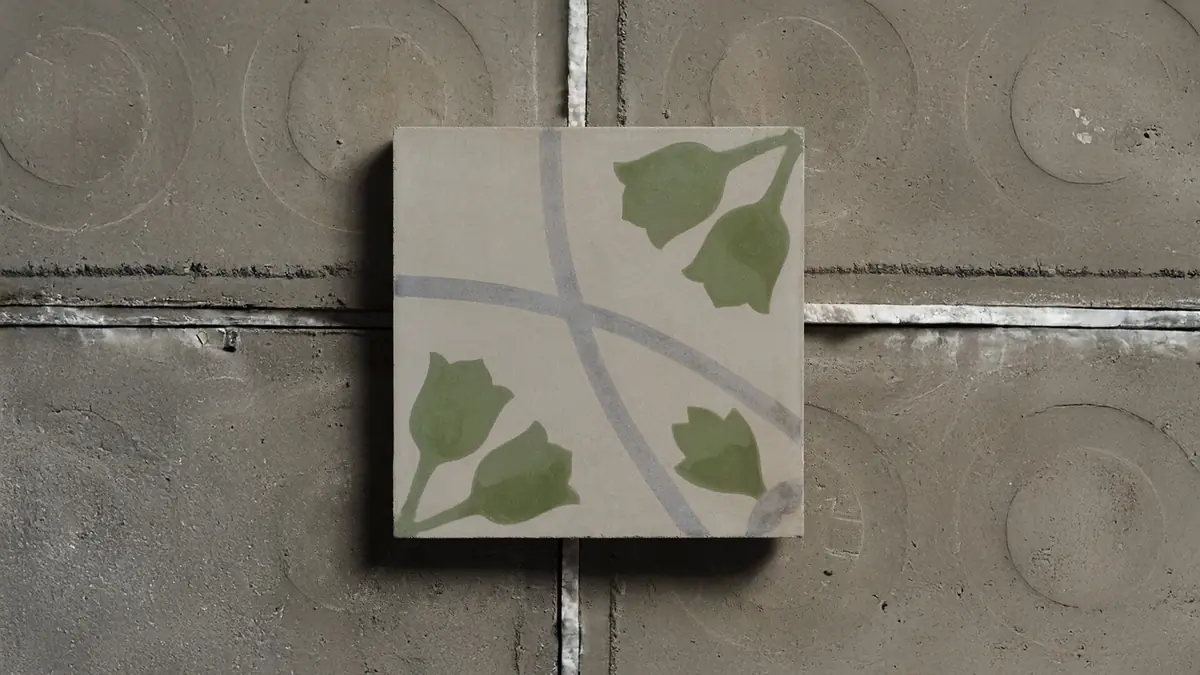 Cementina decorated with green flowers and curved grey lines on a cement background