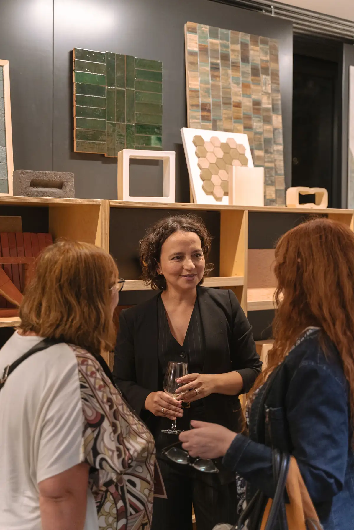 Guests talking in front of ceramic tile samples