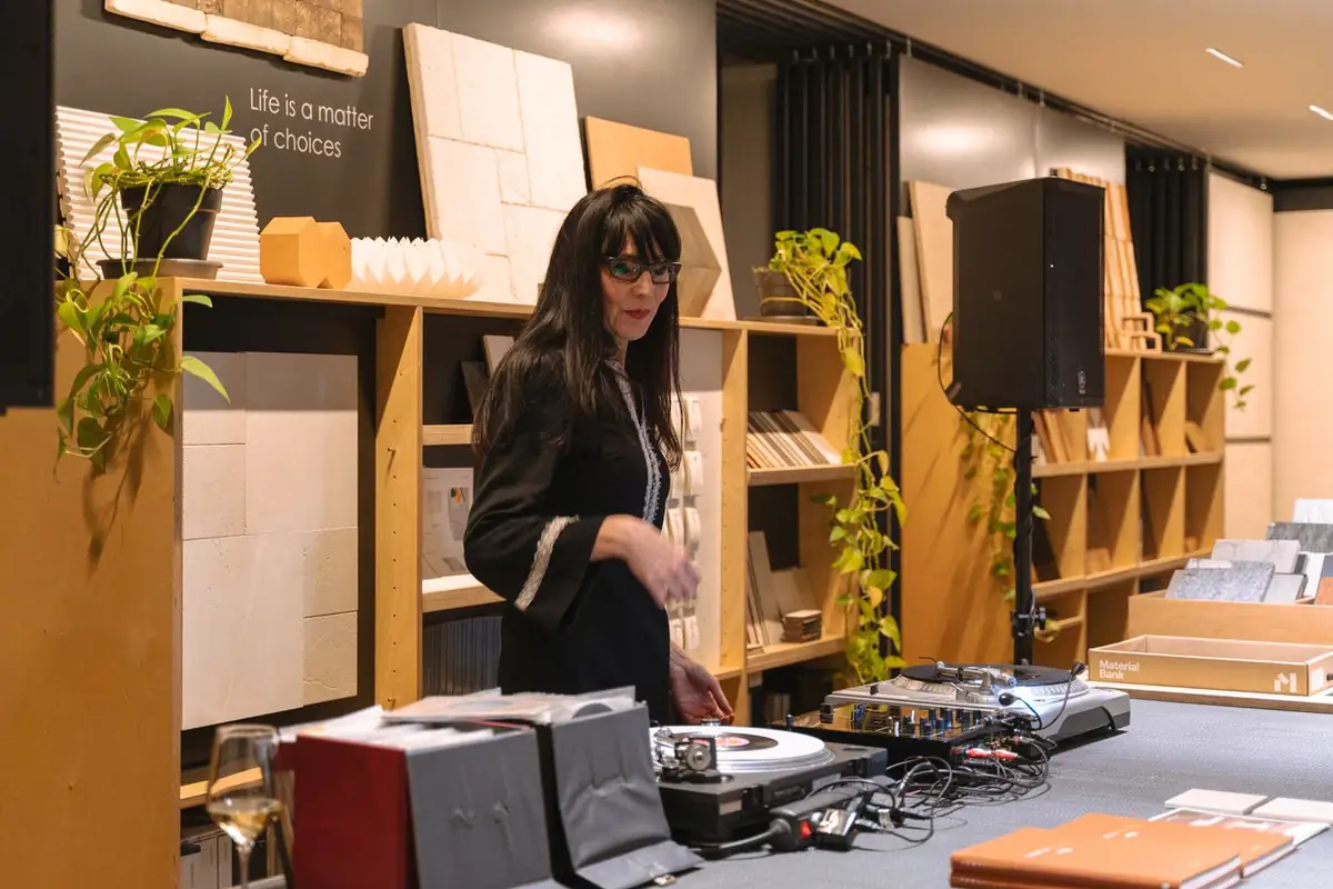 DJ Merli Marlowe at the decks, among sample shelves