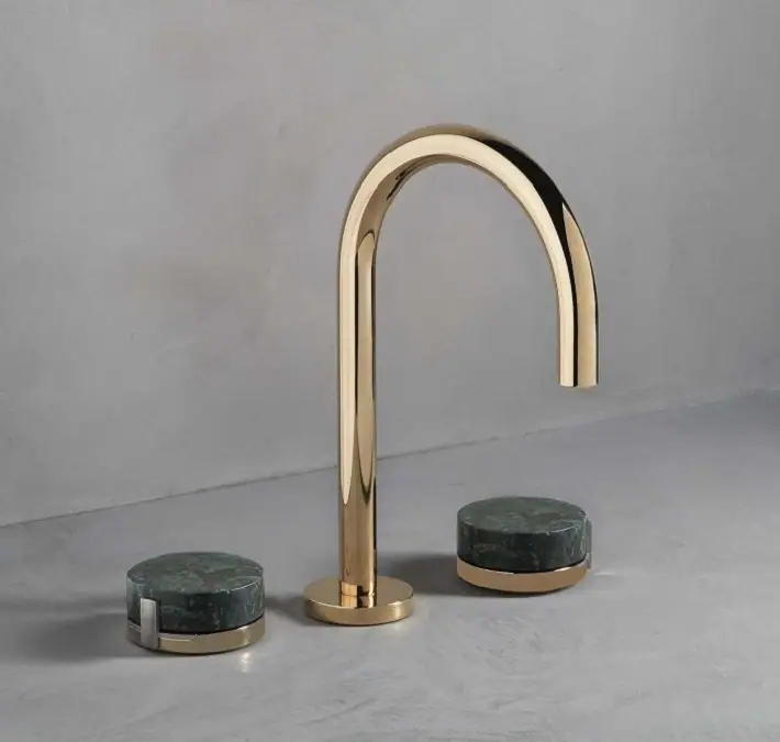 Three-piece basin tap with a tall gold spout and two round green stone handles