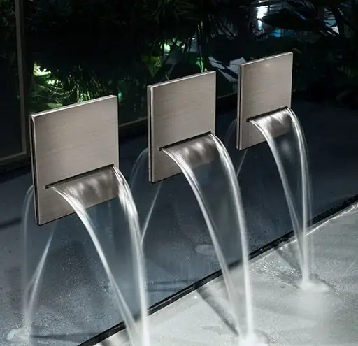 Three square brushed-steel wall spouts pouring water in a cascade onto a sheet of water