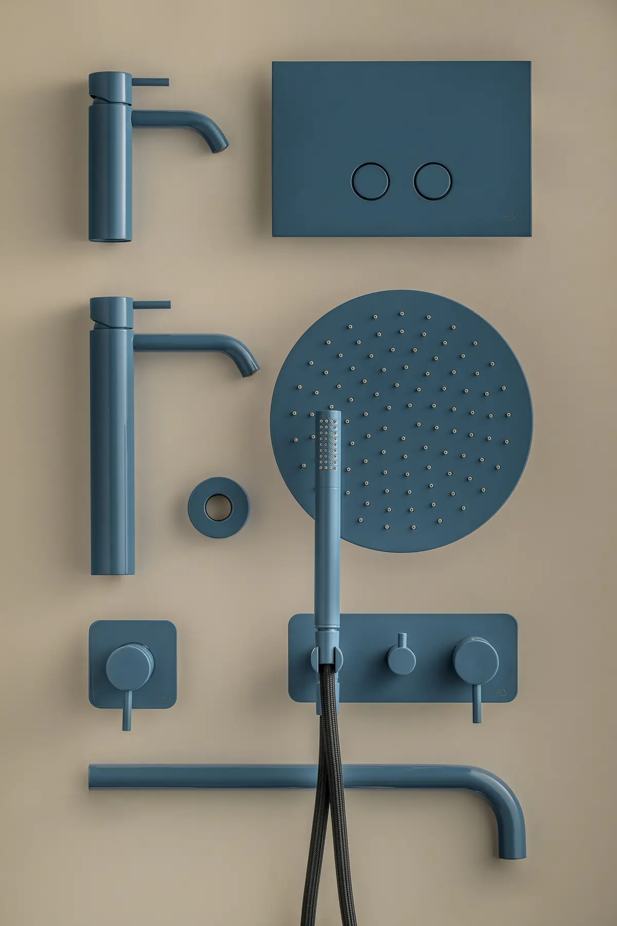 Arrangement of mixers, flush plate, shower head and shower fittings in blue on a beige background