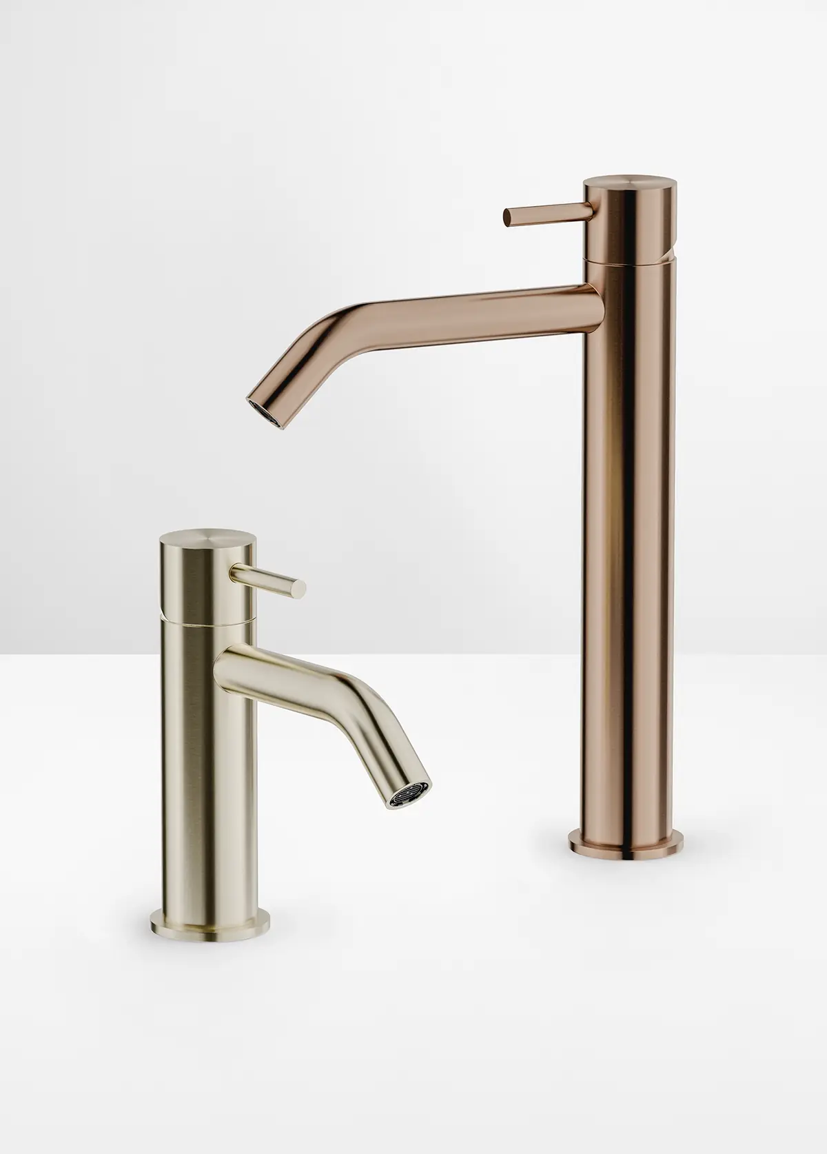 Low basin mixer in a champagne tone and tall basin mixer in a copper tone on a white background