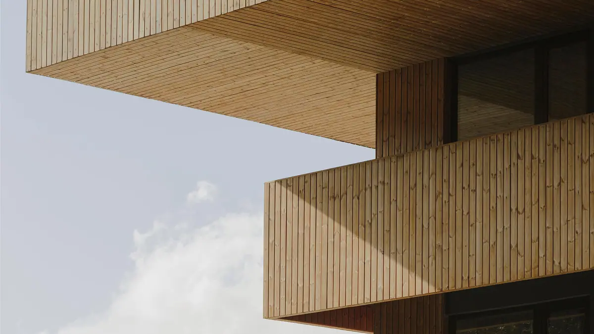 Detail of a building’s cantilevers clad in vertical thermally modified timber boards