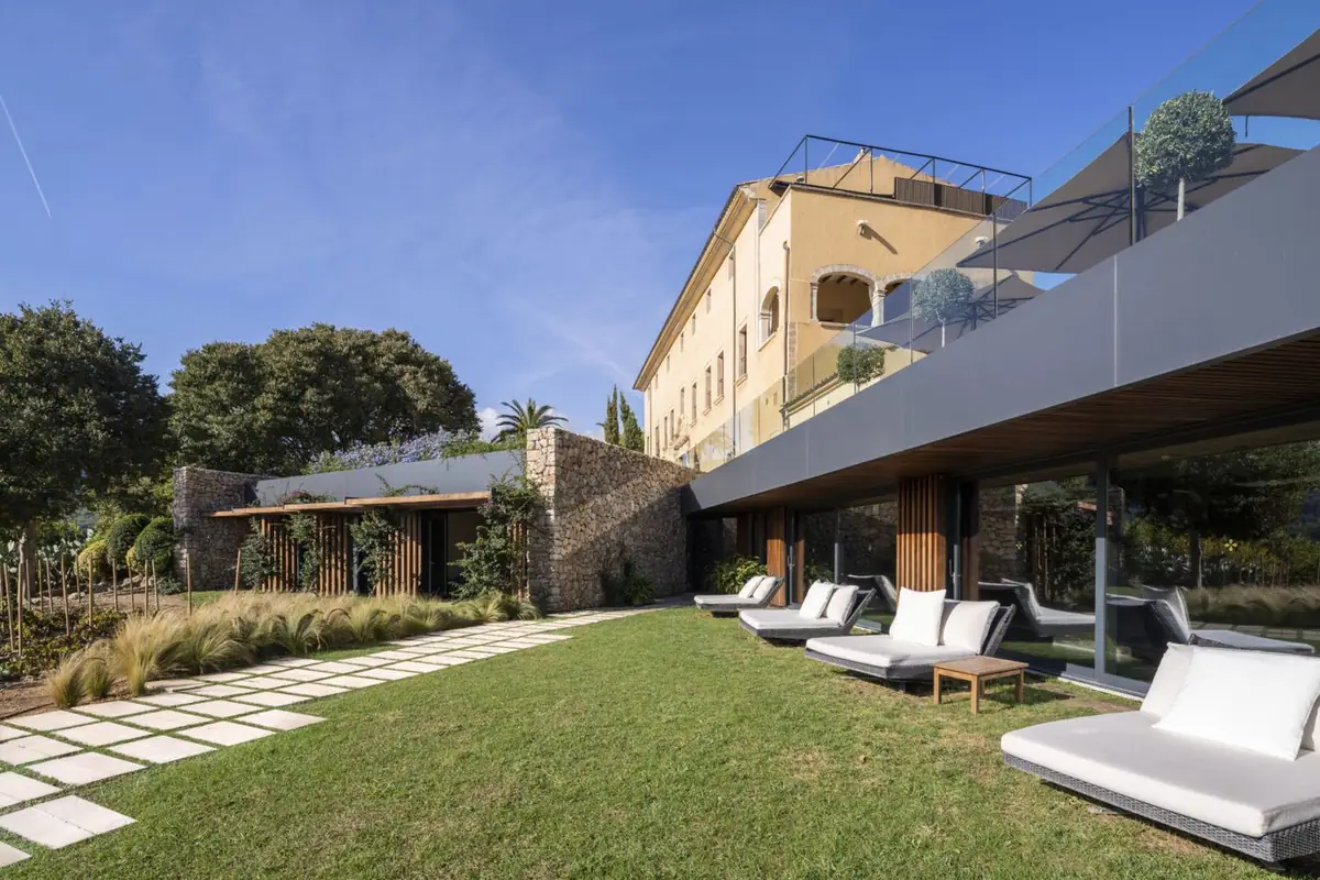 Spa extension with a timber pergola and garden below the monastery façade