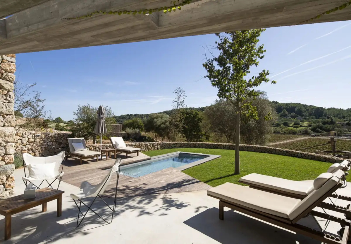 Villa terrace with a private pool, sun loungers and views of the vineyard