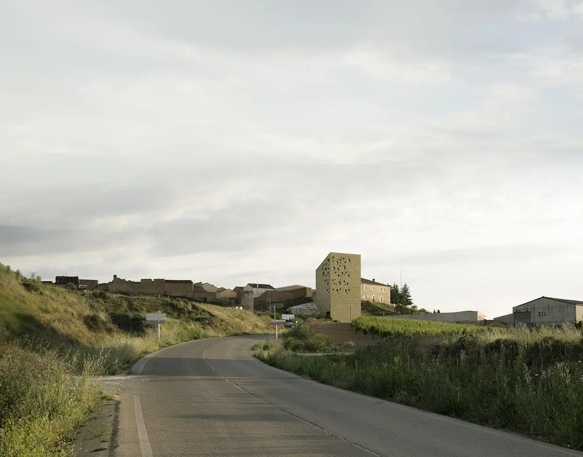 Access road to Roa with the stone tower of the headquarters on the edge of the town