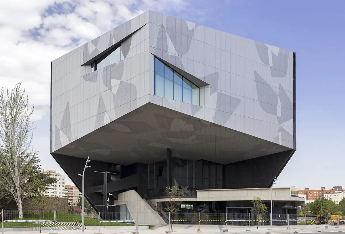 Raised volume of CaixaForum Zaragoza with a perforated panel façade