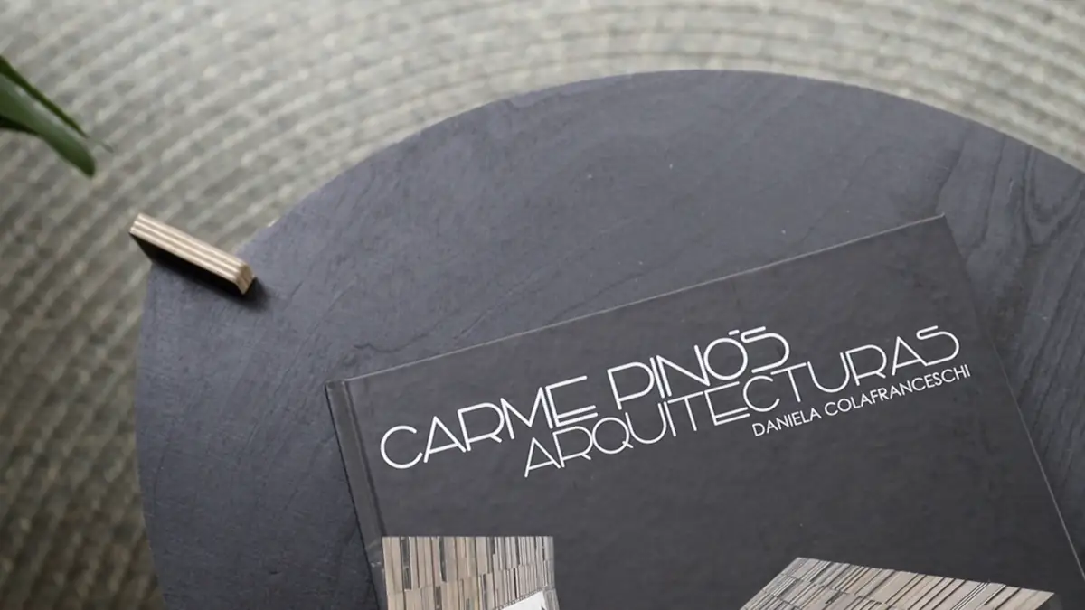 The monograph Carme Pinós. Arquitecturas on a round table in the studio